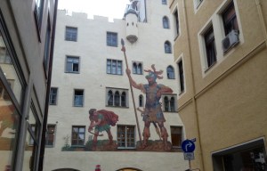 A painting of David & Goliath on a wall in the Old Town, Regensburg, Germany