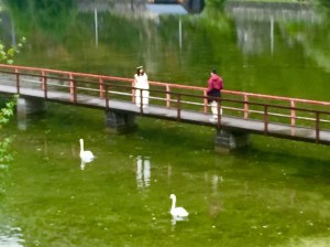 A young groom photographs his bride as we walk from the Obertraun train station to our lodging
