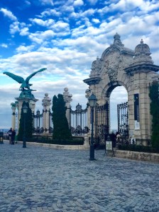 The castle gate on Castle Hill, part of Budapest's extensive World Heritage site, including the Turul statue, a mythical bird seen as the symbol of power, strength, & nobility, carrying the flaming sword of God